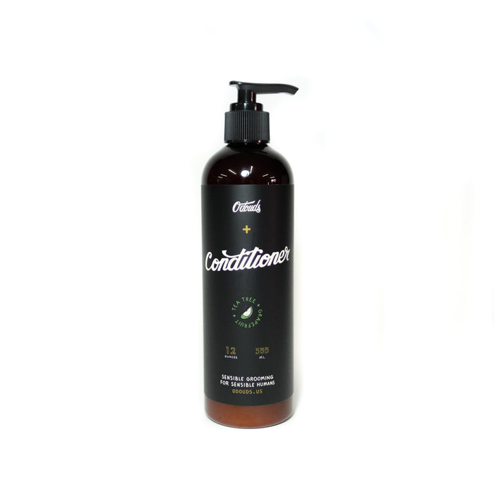Tea Tree & Grapefruit Scented Conditioner amber bottle and black pump on white backdrop